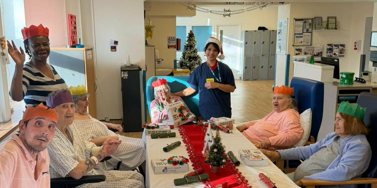 Patients at St Pancras Hospital sitting at a table with their wellbeing boxes on Christmas Day