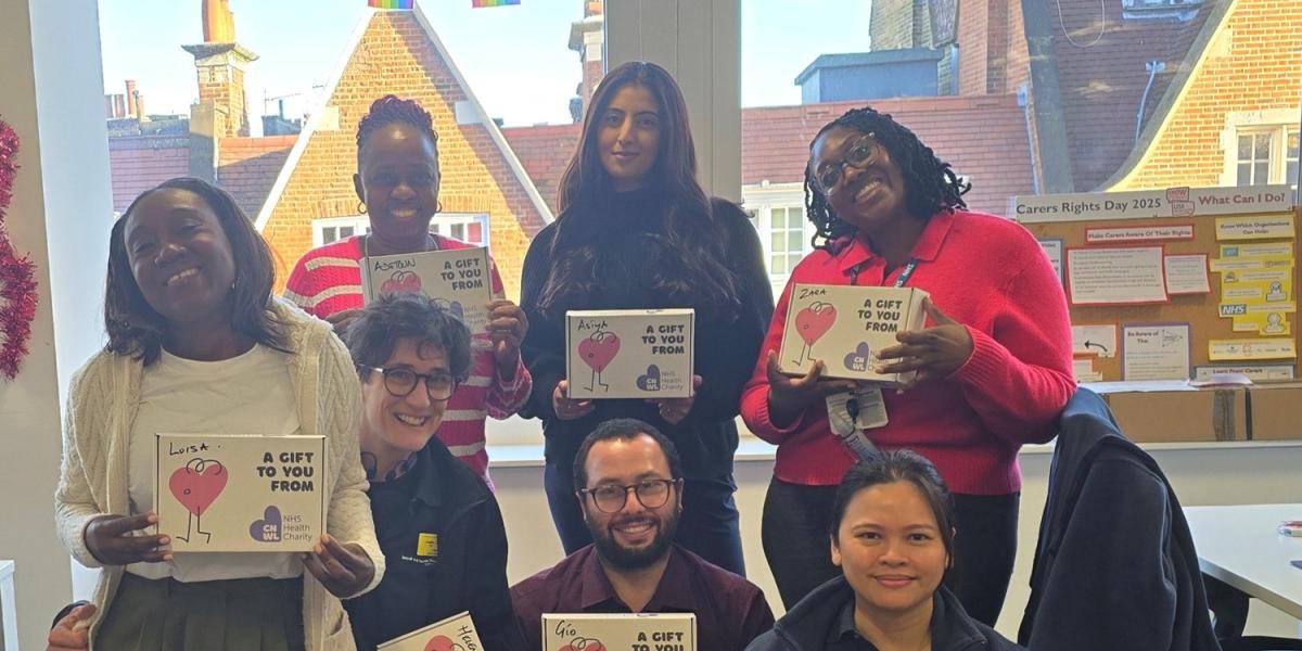 CNWL staff at Community Independent Service smiling with their wellbeing boxes on Christmas Day