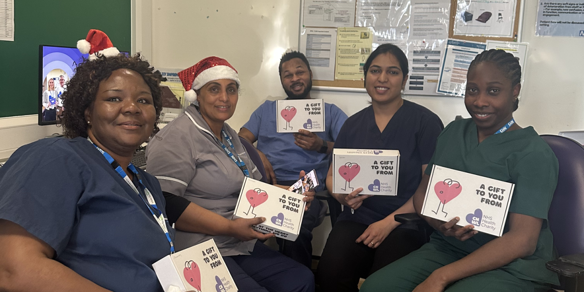 Staff at St Pancras Hospital smiling and holding their wellbeing boxes on Christmas Day