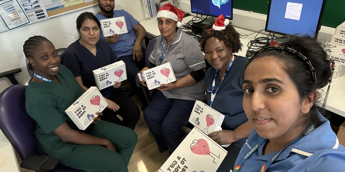 CNWL staff at St Pancras Hospital smiling with their wellbeing boxes on Christmas Day