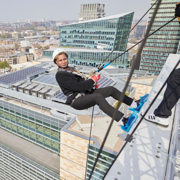 Man abseiling down a building in London