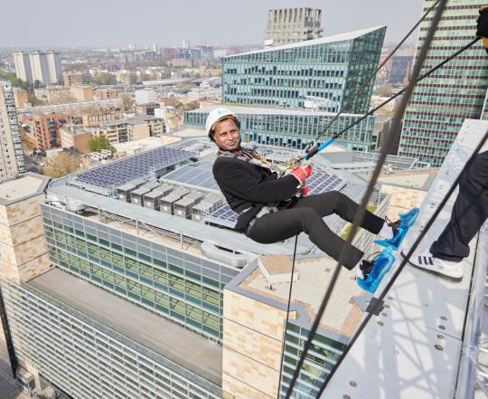 Man abseiling down a building in London