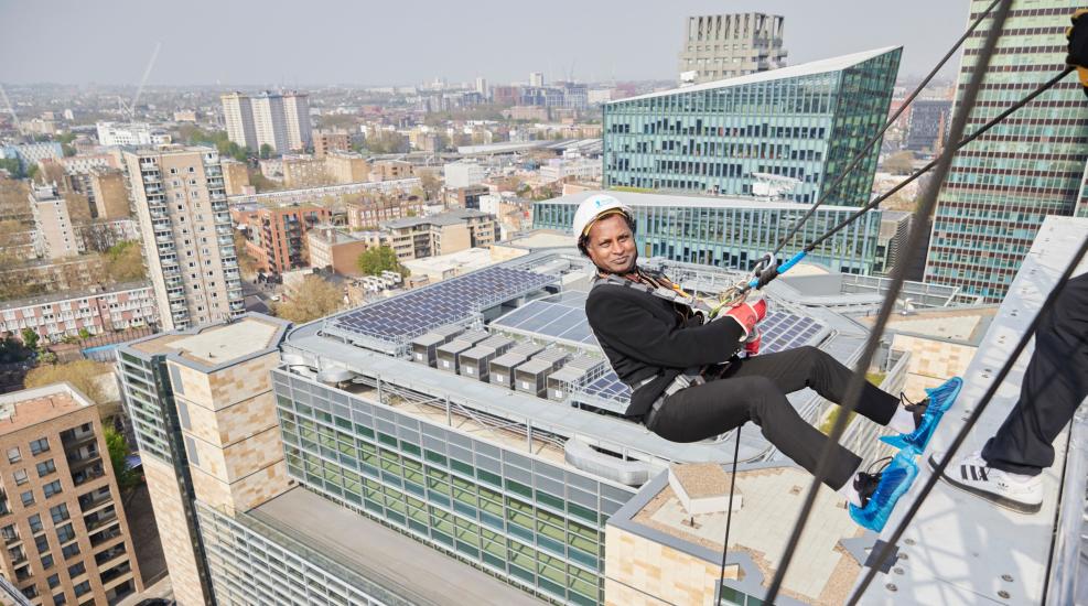 Man abseiling down a building in London