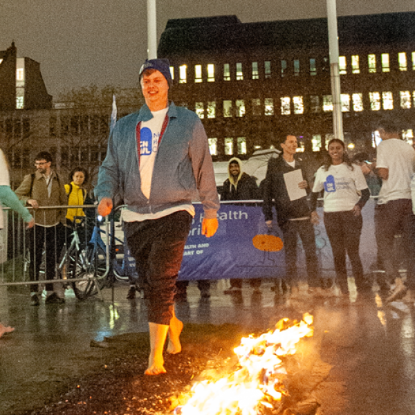 Oscar walking across hot coals