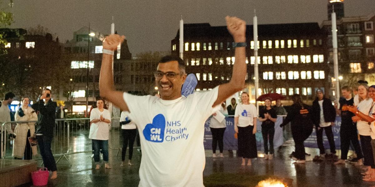 Sambireddy walking across hot coals and cheering