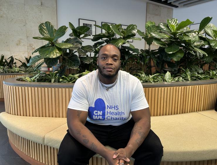 Ayo Sitting Down Inside Wearing Cnwl Nhs Health Charity T Shirt