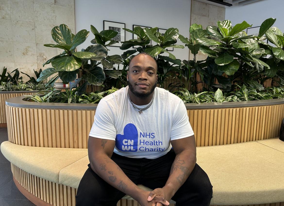 Ayo Sitting Down Inside Wearing Cnwl Nhs Health Charity T Shirt