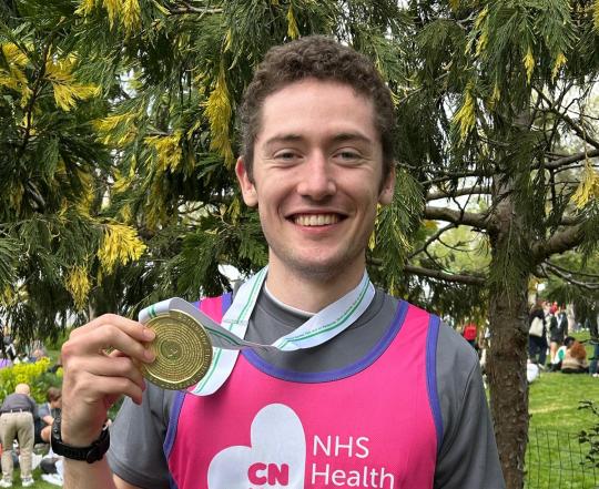 Oli holding his medal