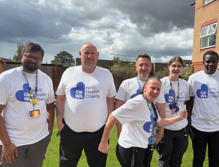 7 members of CNWL TOPAS team standing outside wearing CNWL NHS Health Charity t-shirts