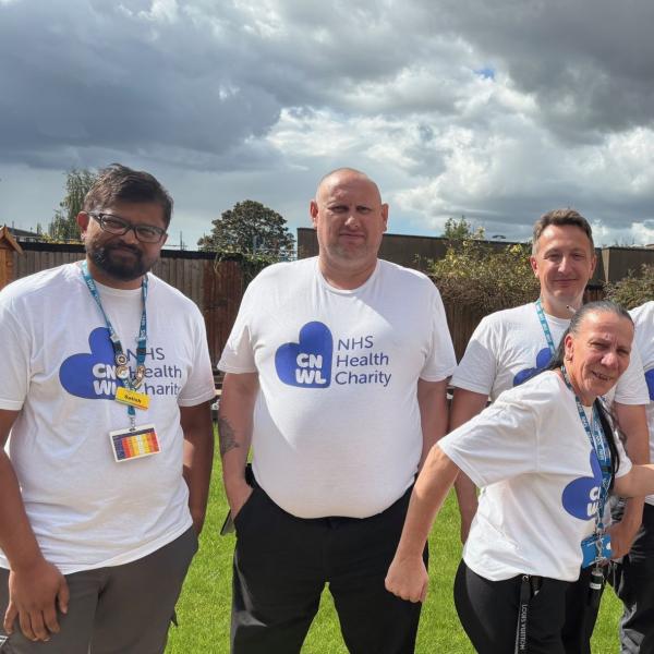 7 members of CNWL TOPAS team standing outside wearing CNWL NHS Health Charity t-shirts