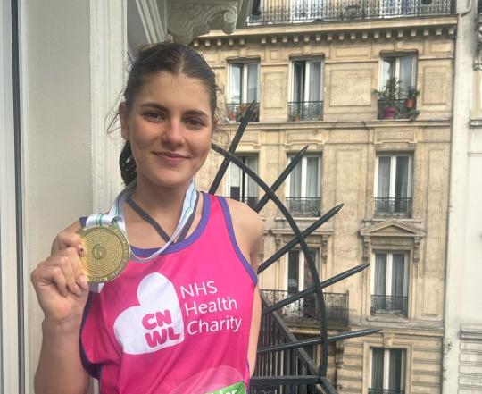 Lucy holding her medal