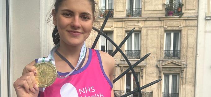 Lucy holding her medal
