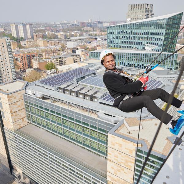 Man Abseiling Down Building At British Land