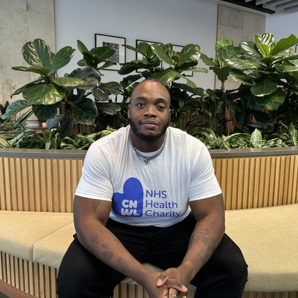 Ayo Sitting Down Inside Wearing Cnwl Nhs Health Charity T Shirt