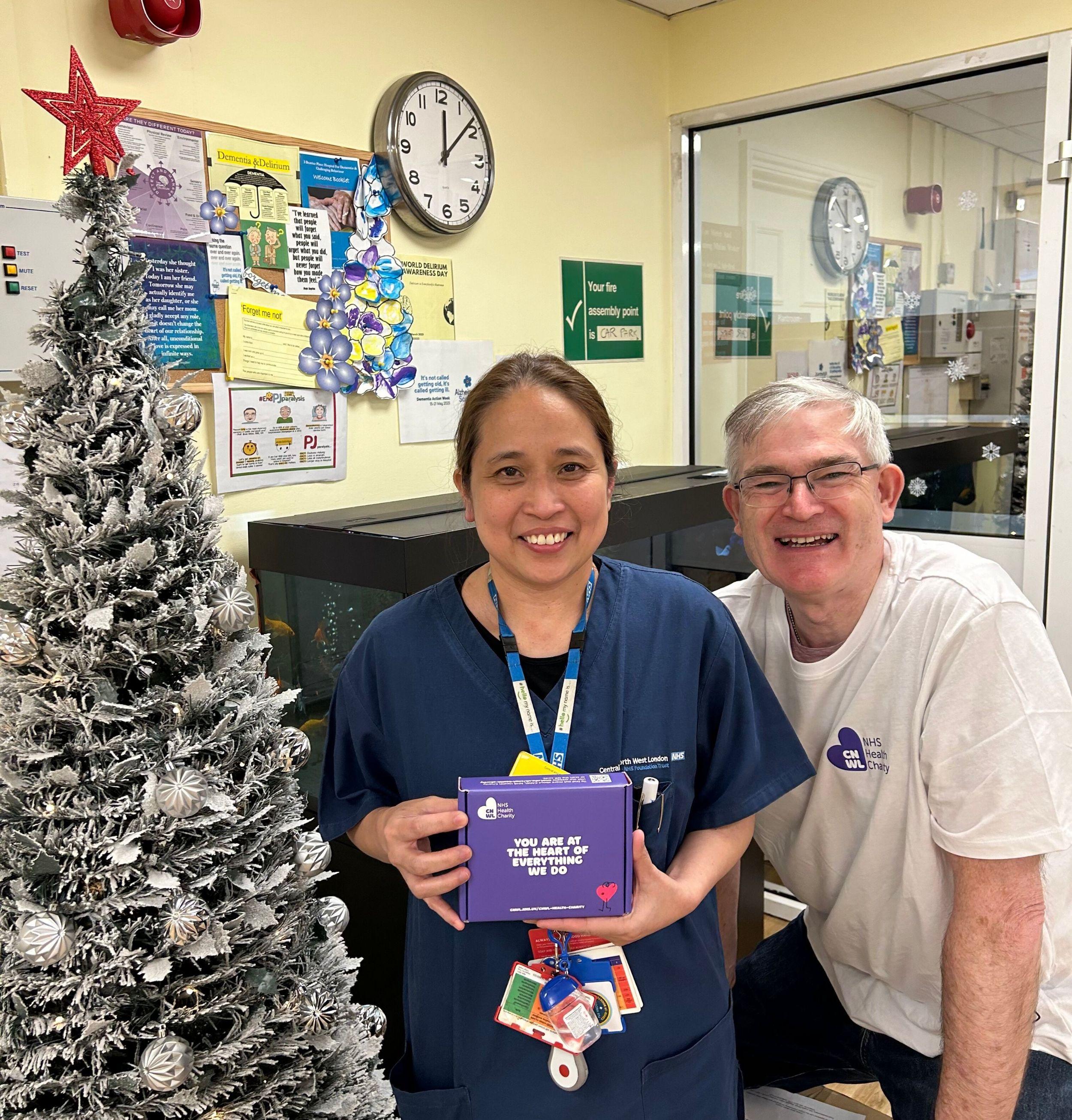 Andrew with nurse holding a wellness box