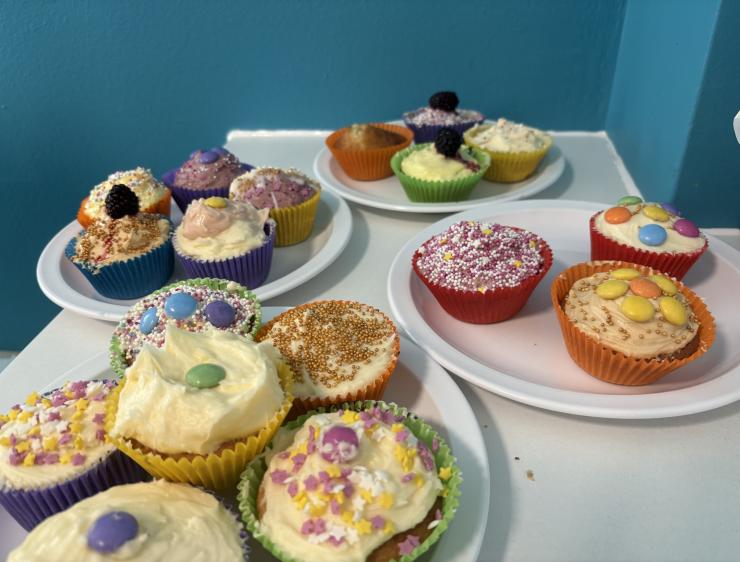 Table with plates filled with cupcakes