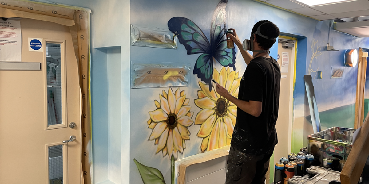 Ash Tree Clinic Mural Artist Spray Painting The Walls