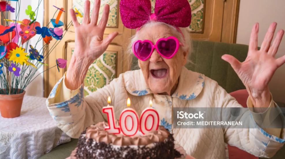 Woman Wearing Sunglasses Celebrating With A Cake
