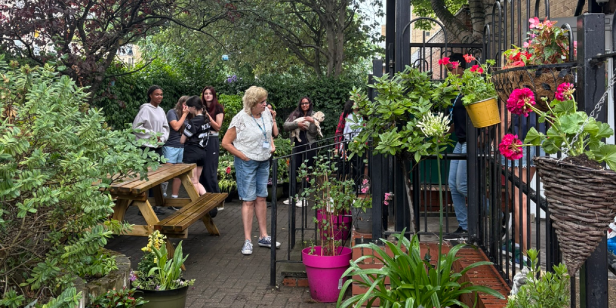 Young People And Staff In Harrow Camhs Garden